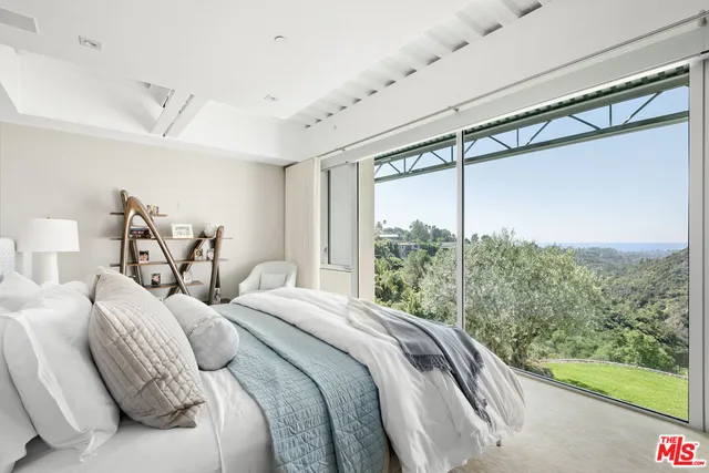 a bedroom with a large bed and a window