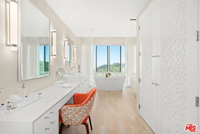 a bathroom with a tub sink and mirror