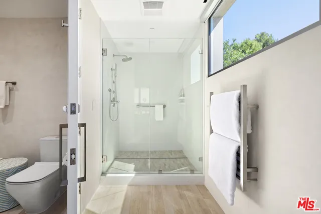 a bathroom with a shower and a toilet