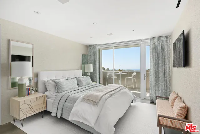 a bedroom with bed and glass door