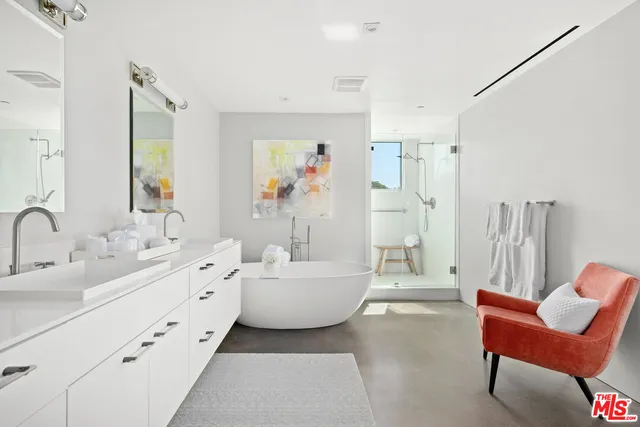 a bathroom with a double vanity sink tub and mirror