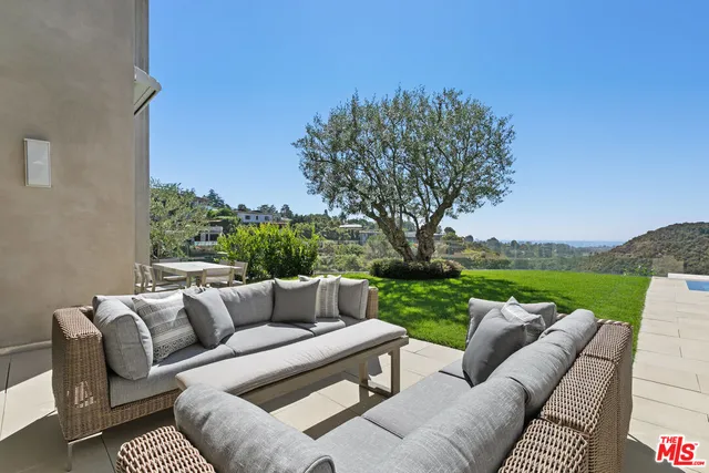 a view of a patio with couches and a big yard