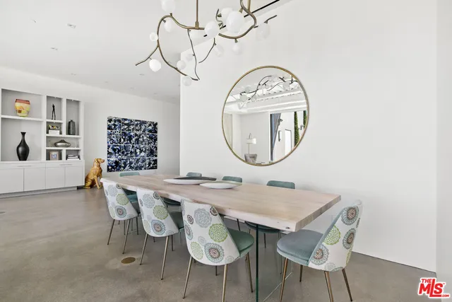a view of a dining room with furniture and a mirror