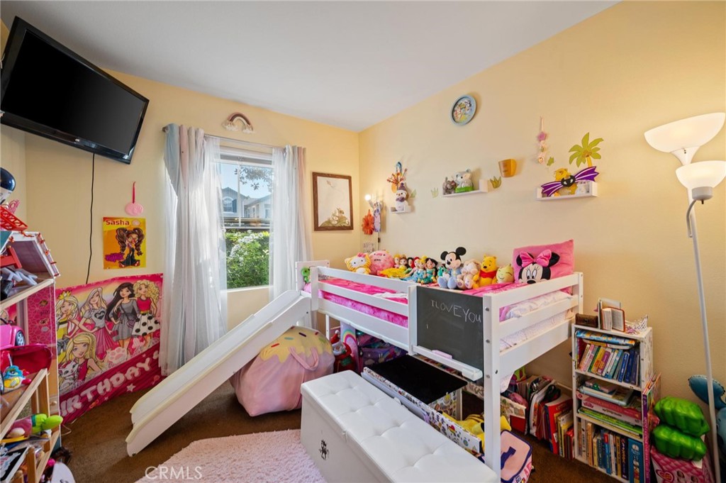 20000 Plum Canyon Road, Unit 316 Saugus, CA 91350 - Photo 15 of 27 a playing room with toys and a flat screen tv