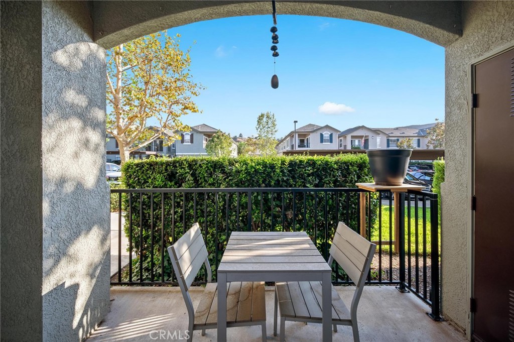 20000 Plum Canyon Road, Unit 316 Saugus, CA 91350 - Photo 18 of 27 a view of a chairs and table in patio with swimming pool
