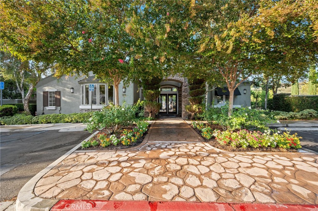 20000 Plum Canyon Road, Unit 316 Saugus, CA 91350 - Photo 20 of 27 a front view of a house with a garden