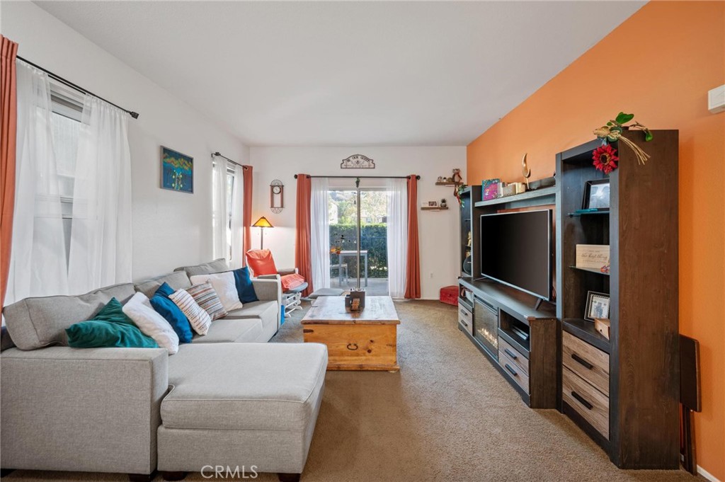 20000 Plum Canyon Road, Unit 316 Saugus, CA 91350 - Photo 2 of 27 a living room with furniture and a flat screen tv