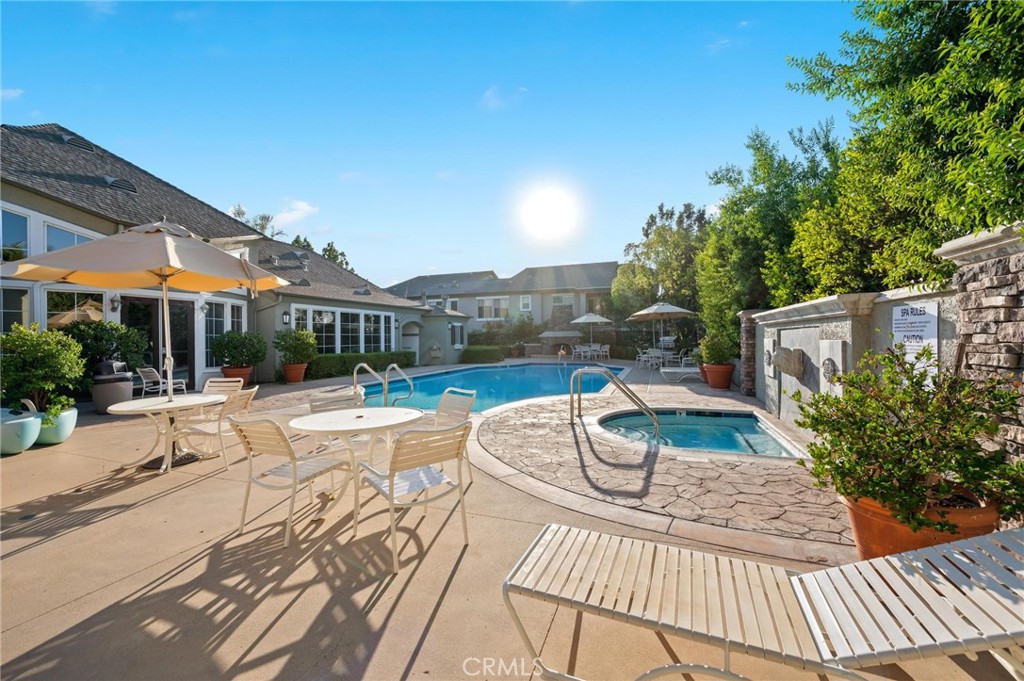 20000 Plum Canyon Road, Unit 316 Saugus, CA 91350 - Photo 23 of 27 a view of a patio with couches table and chairs and potted plants