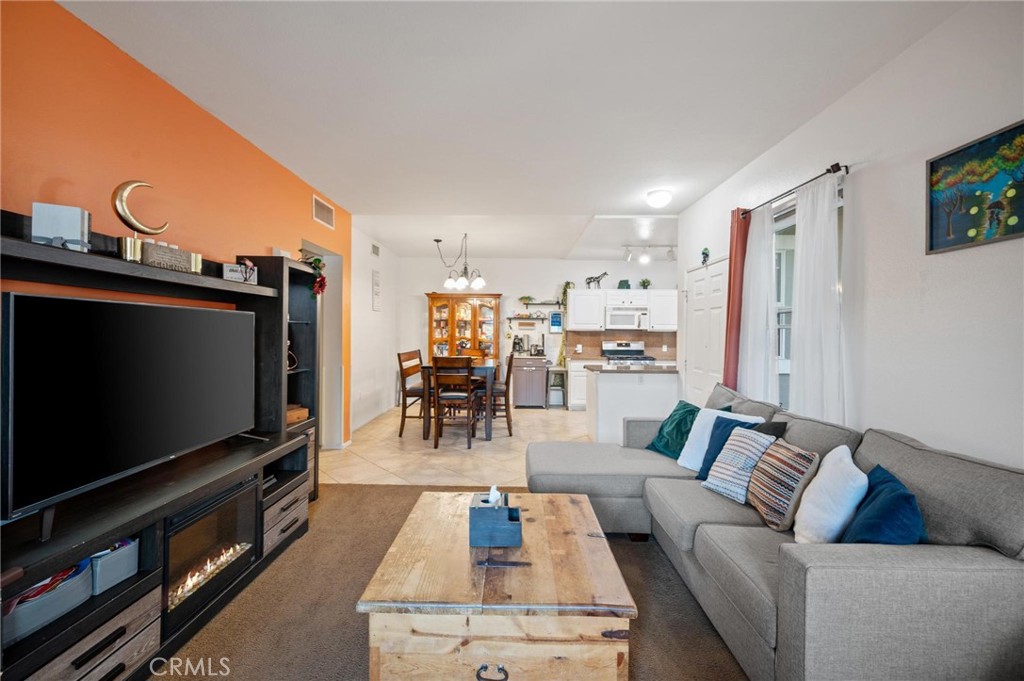 20000 Plum Canyon Road, Unit 316 Saugus, CA 91350 - Photo 4 of 27 a living room with furniture and a flat screen tv