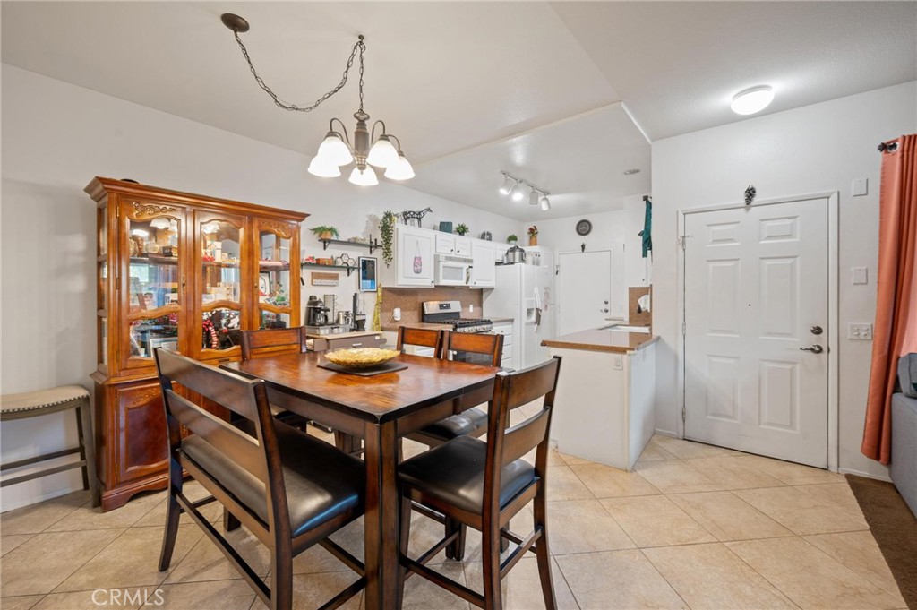 20000 Plum Canyon Road, Unit 316 Saugus, CA 91350 - Photo 5 of 27 a view of a dining room and chandelier