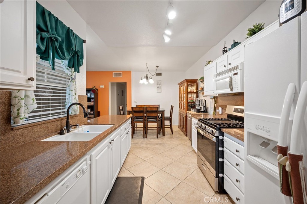 20000 Plum Canyon Road, Unit 316 Saugus, CA 91350 - Photo 9 of 27 a kitchen with stainless steel appliances granite countertop a stove and a sink
