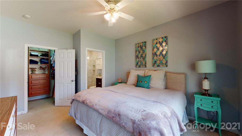 5725 Brookhaven Road Charlotte, NC 28210 - Photo 12 of 39 a bedroom with a bed and a chandelier