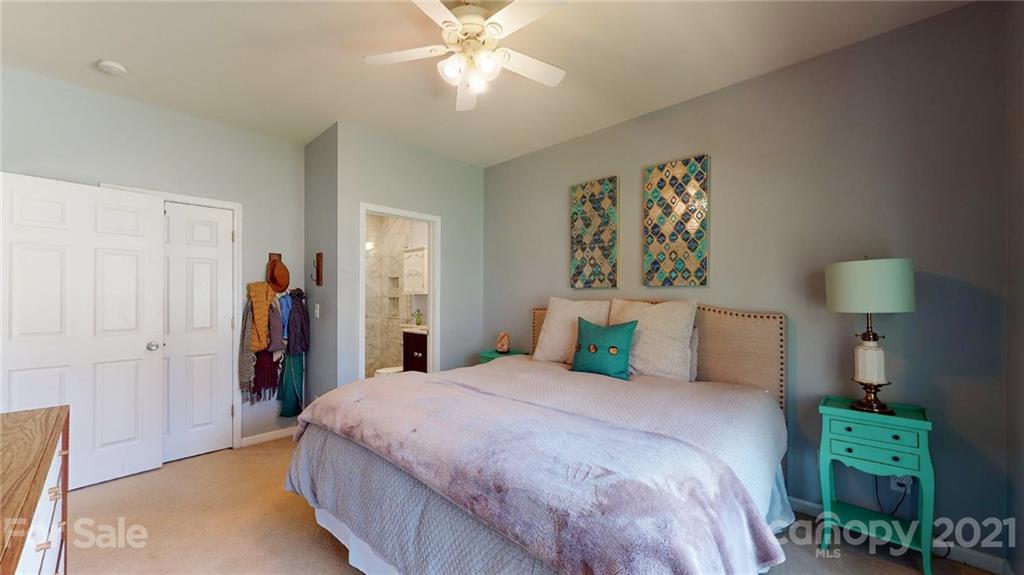 5725 Brookhaven Road Charlotte, NC 28210 - Photo 13 of 39 a bedroom with a bed and a chandelier