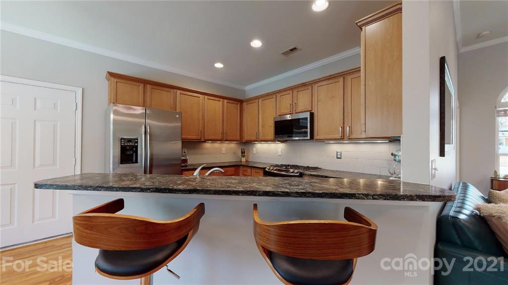5725 Brookhaven Road Charlotte, NC 28210 - Photo 14 of 39 a kitchen with granite countertop a sink a stove and a microwave