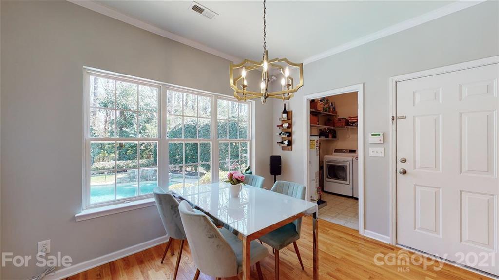 5725 Brookhaven Road Charlotte, NC 28210 - Photo 15 of 39 a view of a dining room with furniture window and wooden floor
