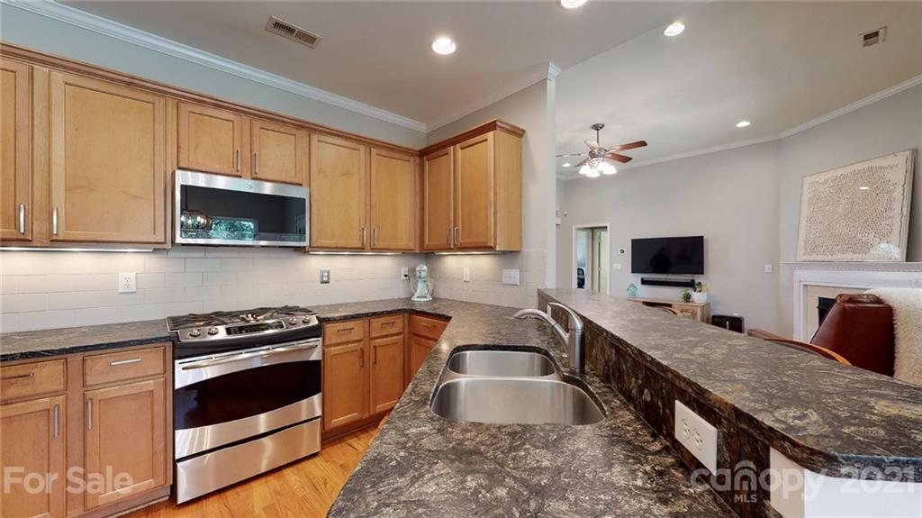 5725 Brookhaven Road Charlotte, NC 28210 - Photo 17 of 39 a kitchen with granite countertop a stove and a sink