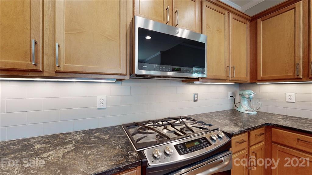 5725 Brookhaven Road Charlotte, NC 28210 - Photo 18 of 39 a kitchen with a stove and a microwave