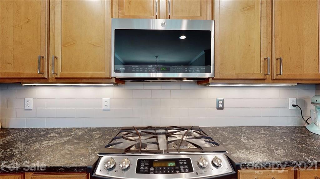 5725 Brookhaven Road Charlotte, NC 28210 - Photo 19 of 39 a kitchen with a stove and a microwave