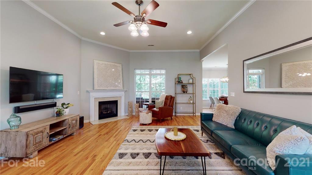 5725 Brookhaven Road Charlotte, NC 28210 - Photo 4 of 39 a living room with furniture a flat screen tv and a fireplace