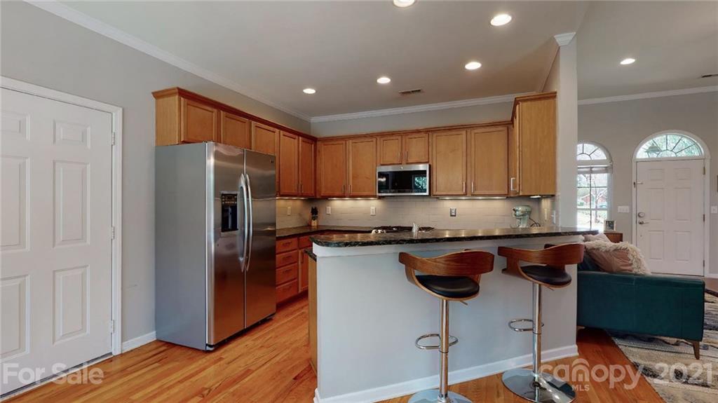 5725 Brookhaven Road Charlotte, NC 28210 - Photo 32 of 39 a kitchen with stainless steel appliances granite countertop a refrigerator a stove a sink and a microwave