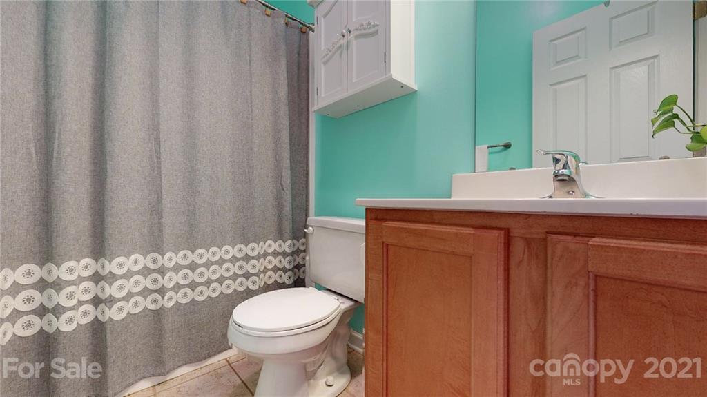 5725 Brookhaven Road Charlotte, NC 28210 - Photo 34 of 39 a bathroom with a sink a toilet and shower
