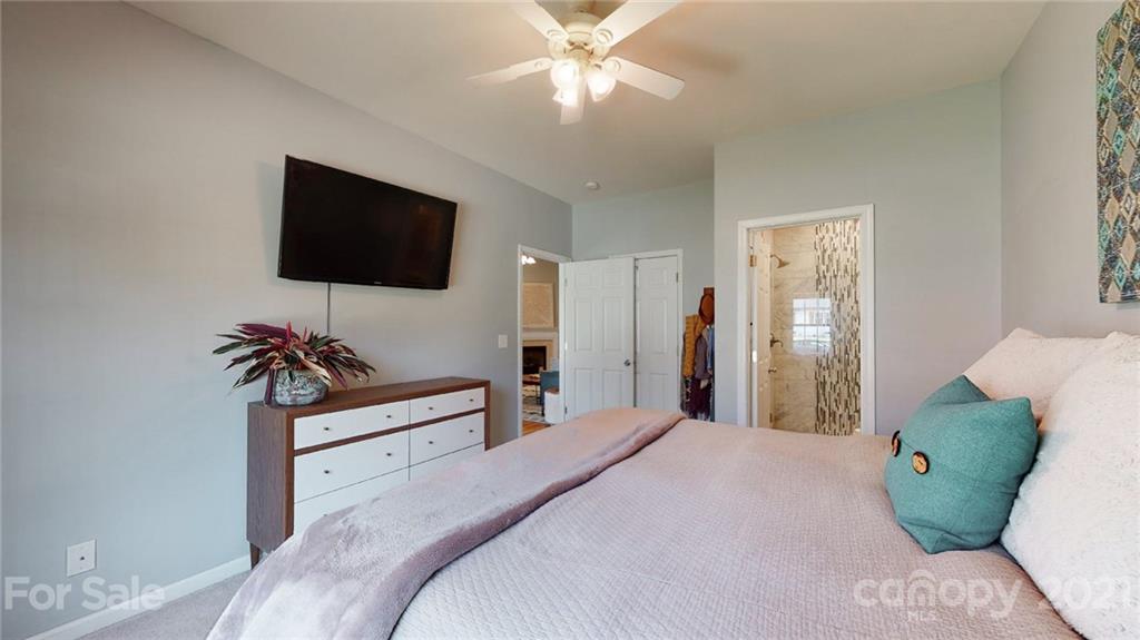 5725 Brookhaven Road Charlotte, NC 28210 - Photo 37 of 39 a bedroom with a bed and a flat screen tv