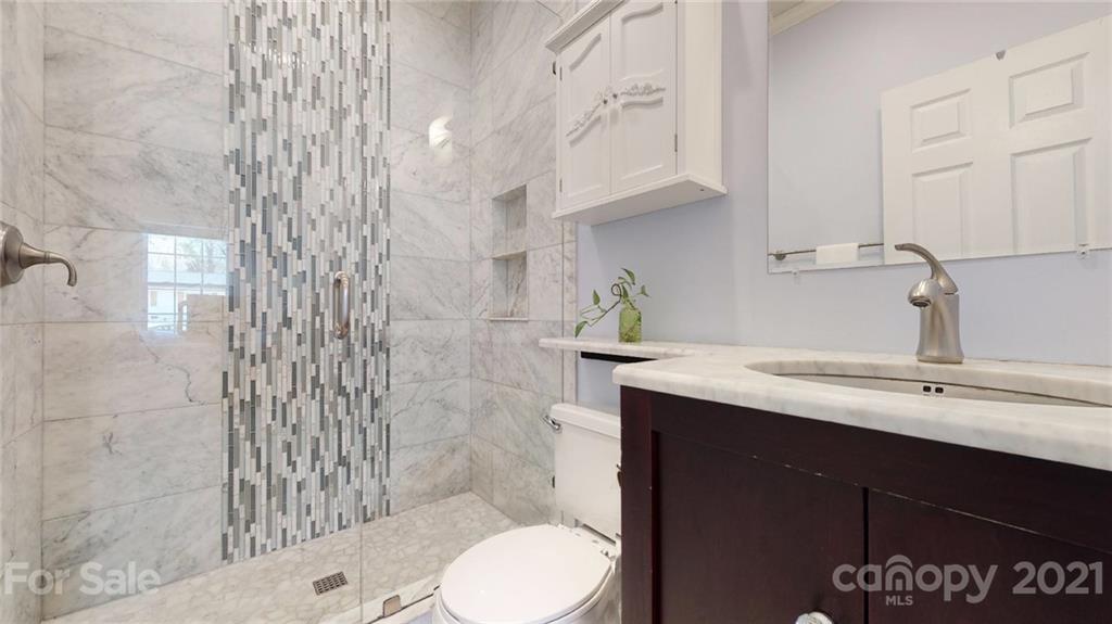5725 Brookhaven Road Charlotte, NC 28210 - Photo 38 of 39 a bathroom with a sink a toilet and shower