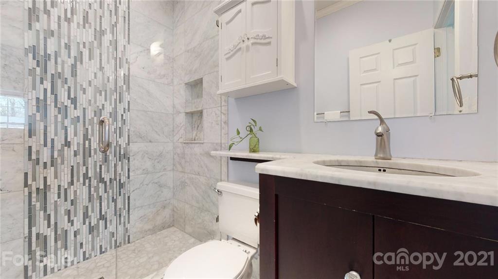5725 Brookhaven Road Charlotte, NC 28210 - Photo 39 of 39 a bathroom with a sink toilet and shower