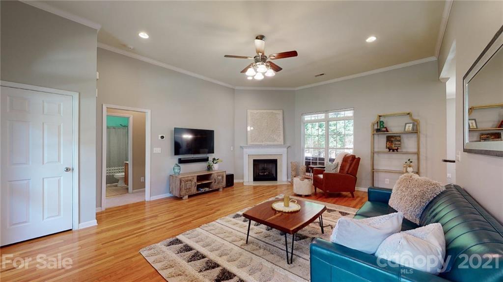 5725 Brookhaven Road Charlotte, NC 28210 - Photo 5 of 39 a living room with furniture a flat screen tv and wooden floor
