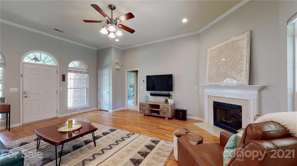 5725 Brookhaven Road Charlotte, NC 28210 - Photo 9 of 39 a living room with furniture a fireplace and a flat screen tv