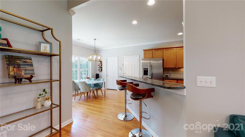5725 Brookhaven Road Charlotte, NC 28210 - Photo 10 of 39 a view of a dining room with furniture window and wooden floor