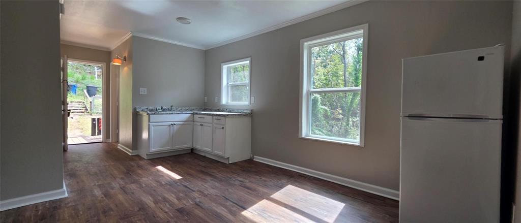 333 Canal Street Ringgold, LA 71068 - Photo 5 of 33 a view of a kitchen with wooden floor electronic appliances and windows