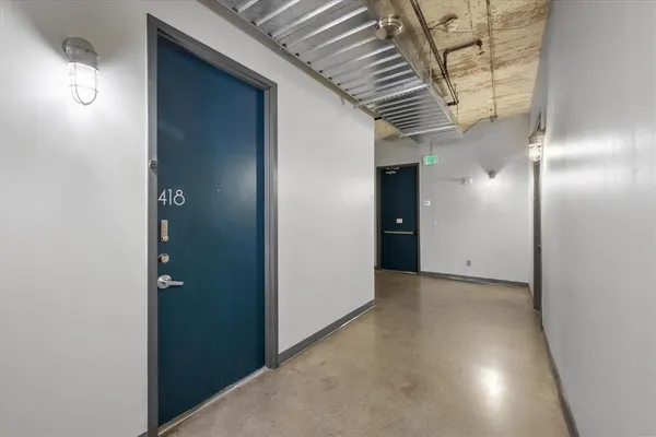 a view of a hallway with wooden shelves