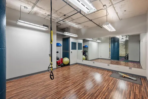 a view of a room with wooden floor