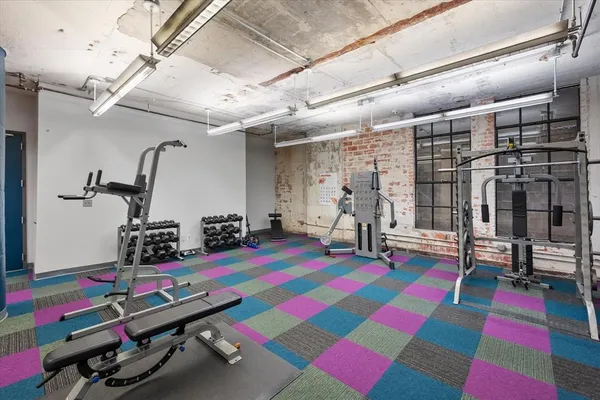 a room with gym equipment and a table