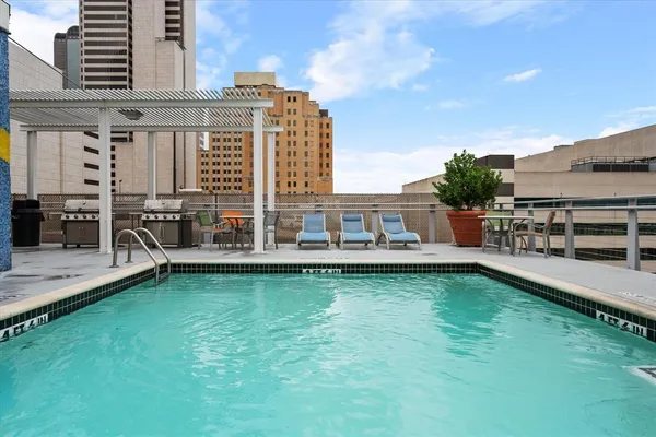 a view of a swimming pool with a table and chairs