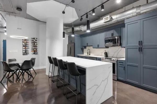 a kitchen with cabinets and chairs