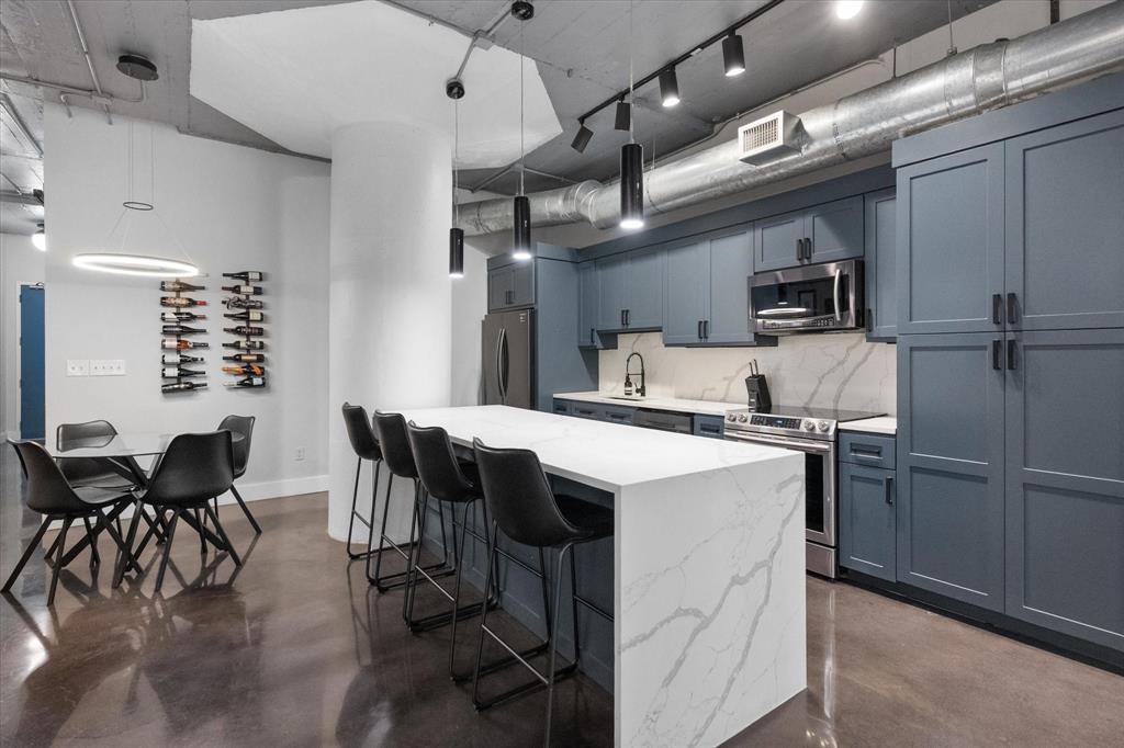 1122 Jackson Street, Unit 418 Dallas, TX 75202 - Photo 2 of 23 a kitchen with cabinets and chairs