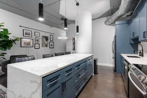 a kitchen with a stove a refrigerator and a sink