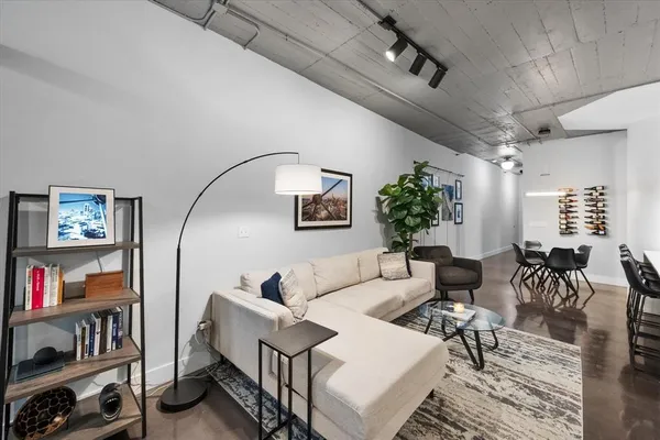 a living room with furniture and a potted plant