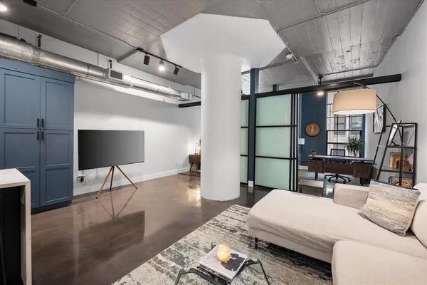 a living room with furniture and a flat screen tv