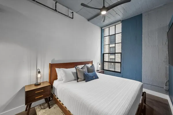 a bedroom with a bed and a window