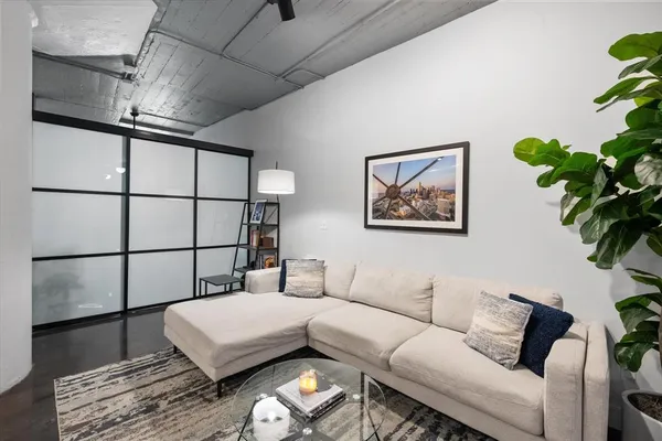 a living room with furniture a plant and a potted plant