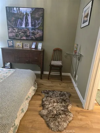 a bed sitting in a bedroom next to a window with rug