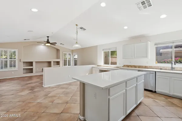 a kitchen with a sink a counter top space and appliances
