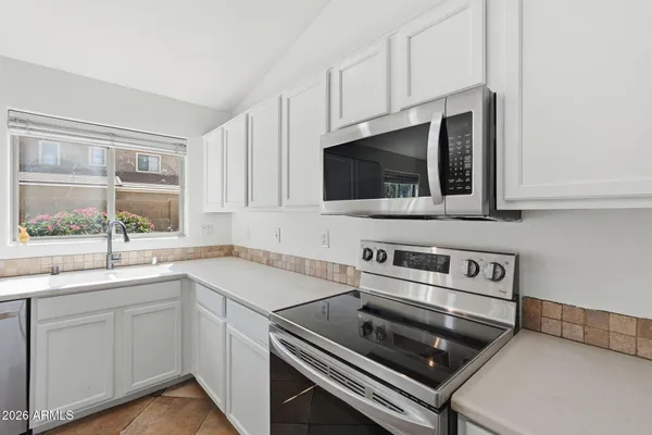a kitchen with a sink stove and microwave
