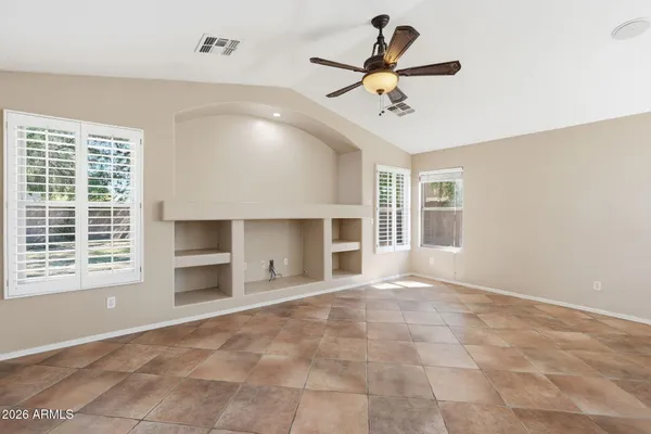 a view of a livingroom with a ceiling fan and window