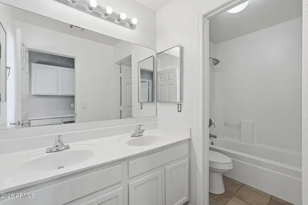a spacious bathroom with a double vanity sink shower and a mirror