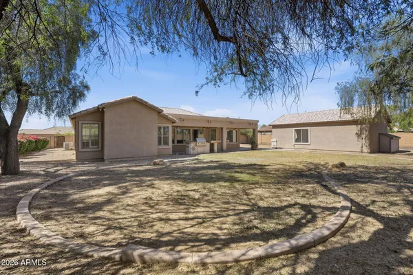 a view of a house with backyard and trees