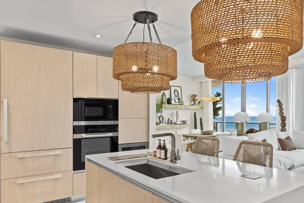 a kitchen with stainless steel appliances granite countertop a sink a stove and white cabinets